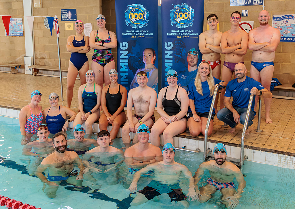 A group image of RAF Brize Norton swimming club members, standing on the pool edge and in the water.